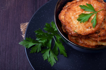 Vegetable pancakes topped with parsley leaves in a blue bowl