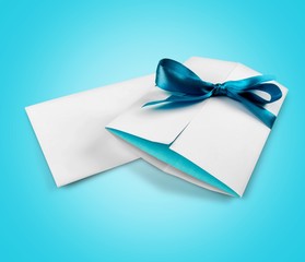Invitation envelope with blue bow and blank letter isolated on