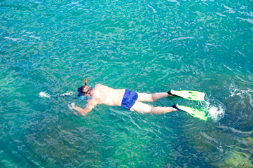 Diver hunts for fish with an underwater gun.