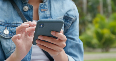 Woman use of mobile phone at the park