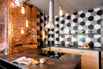 Modern loft kitchen room made in pink and grey colors with copper wall and hexagonal tiles