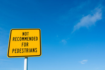 Caution signs for pedestrian on a narrow mountain road