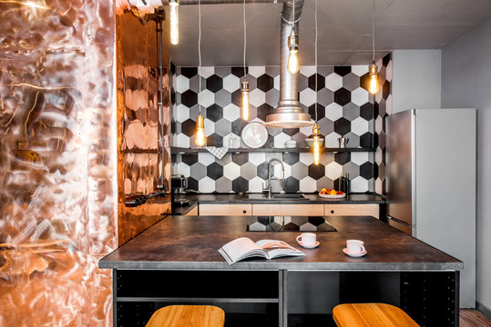 Modern loft kitchen room made in pink and grey colors with copper wall and hexagonal tiles