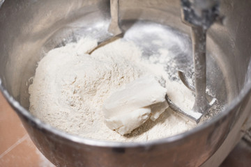 Close up of dough in electric bakery mixer