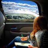 Young woman looking out through car window