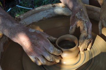 Potter teaches modeling pots and vases of clay on the Potter's wheel