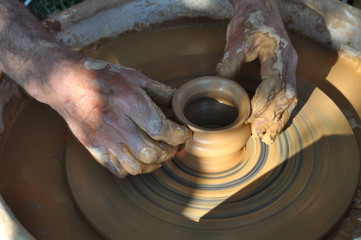 Potter teaches modeling pots and vases of clay on the Potter's wheel