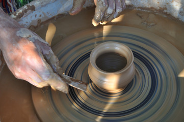 Potter teaches modeling pots and vases of clay on the Potter's wheel