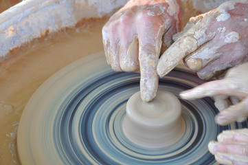 Potter teaches modeling pots and vases of clay on the Potter's wheel
