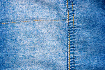 Blue washed faded jeans texture with seams