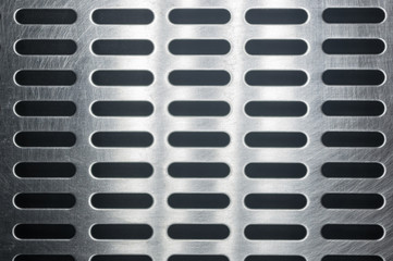 stainless steel grating with oblong holes, close-up
