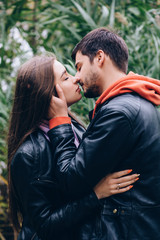 Romantic holidays guy and girls in autumn park.
Funny games of husband and wife in nature.