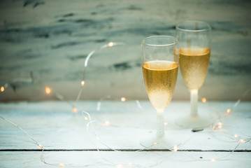 two glasses of champagne on background of lights