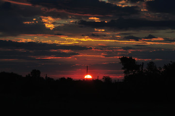 Beautiful sunrise in the village with clouds and orange sky