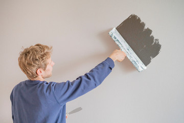 putty knife making the wall repair f