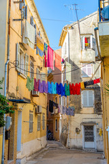 Fototapeta na wymiar View of typical narrow street of an old town of Corfu in Greece