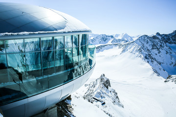 Cafe 3440 on the Pitztal Glacier. Austrias highest coffee house at mountain peak in Tirol, Pitztal Glacier and panoramic view of snow covered mountain range - obrazy, fototapety, plakaty