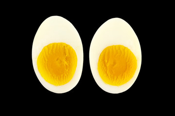 Boiled egg slices  isolated on black background.