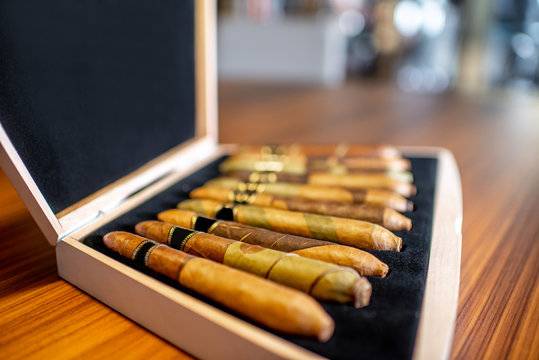 Close-up of luxury cigar set on the wooden table indoors