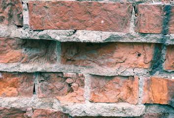 The texture of the brickwork with broken bricks