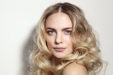 Young beautiful blonde woman with long curly hair