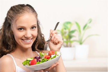 Young woman with bowl of salad on