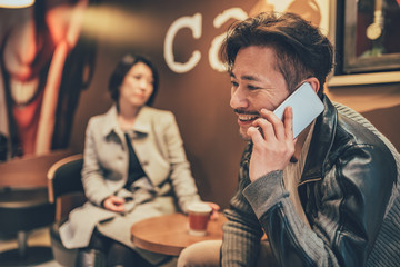 Asian tourist couple on the mobile phone