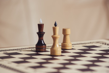 Checkmate position on chessboard. Black king defeated by white king and rook.