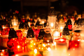 Many burning candles in the cemetery at night on the occasion souls of the deceased