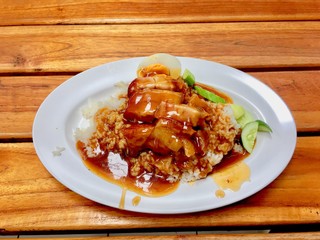 barbuced crispy pork in red sauce with rice - One of the most popular menu in this era of Thailand. Let's look at the hot rice, crispy pork with crispy salty red sauce.