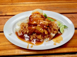 barbuced crispy pork in red sauce with rice - One of the most popular menu in this era of Thailand. Let's look at the hot rice, crispy pork with crispy salty red sauce.