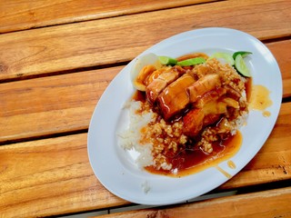 barbuced crispy pork in red sauce with rice - One of the most popular menu in this era of Thailand. Let's look at the hot rice, crispy pork with crispy salty red sauce.