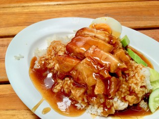 barbuced crispy pork in red sauce with rice - One of the most popular menu in this era of Thailand. Let's look at the hot rice, crispy pork with crispy salty red sauce.