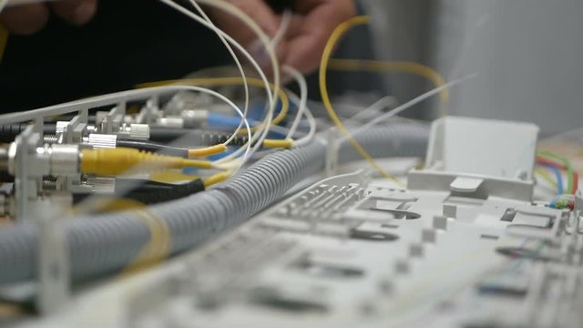 Technicians are installing optic fiber with cable ties.