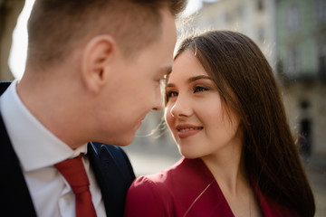 Sexy passion couple in love. Portrait of beautiful young man and woman dressed in classic clothes, studio shot over grey background