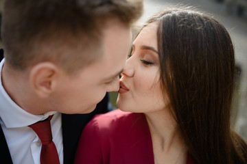 Sexy passion couple in love. Portrait of beautiful young man and woman dressed in classic clothes, studio shot over grey background