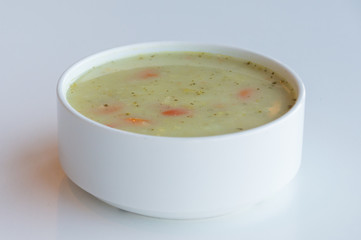 Fresh vegetable soup in white bowl.