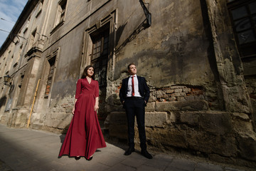 Young couple in a candid shot. They are walking in the street.