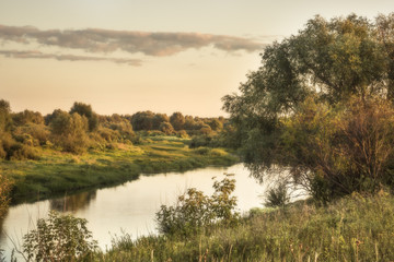 Fototapeta na wymiar Rural countryside river trees landscape sunset on riverbank 