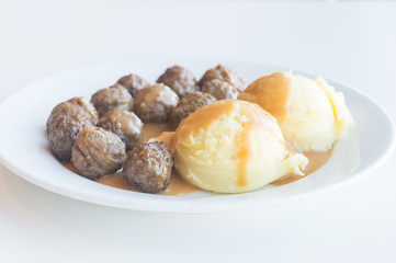 Klopsiki with potatoes and sauce. Klopsiki is meatballs.