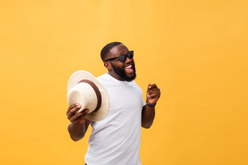 Young black man top dancing isolated on a yellow background.