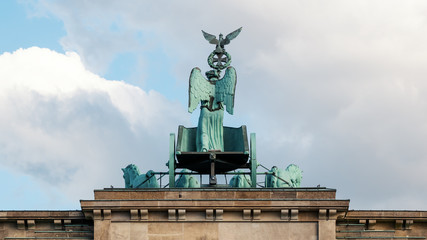 Fototapeta premium The Quadriga of Brandenburg Gate Against A Blue Cloudy Sky In Berlin, Germany