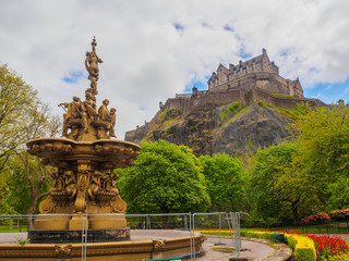 Edinburgh Castle and Ross Fountain seen from the Princes Street Gardens on a bright sunny day.