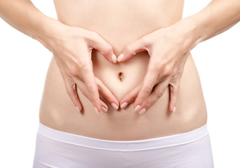 Beautiful woman body on the belly with hands heart on a white background. Isolation