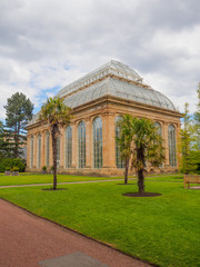 Fototapeta na wymiar The Victorian Palm House at the Royal Botanic Gardens, a public park in Edinburgh, Scotland, UK.