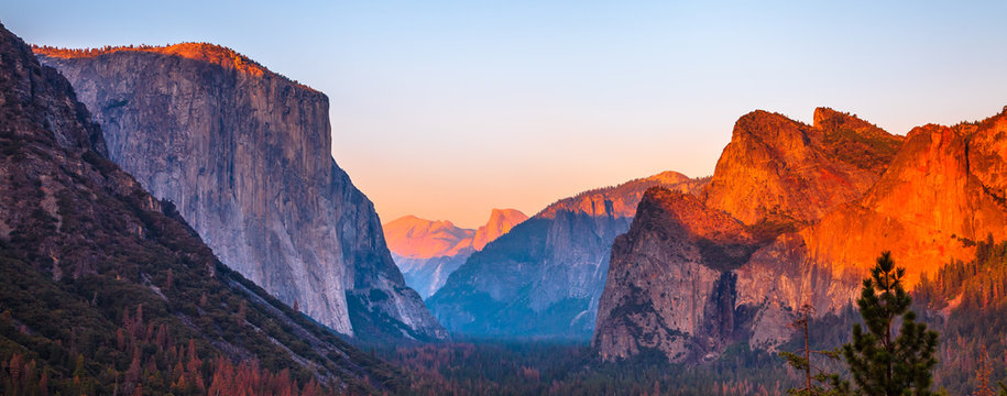 Yosemite National Park Tunnel View overlook at sunset. Front view panorama of popular El Capitan and Half Dome at deep red sunset. Summer american holidays. California, United States. © bennymarty