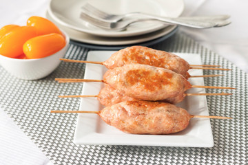 Minced turkey kebabs on square white plate
