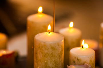 Christmas golden candles on the fireplace