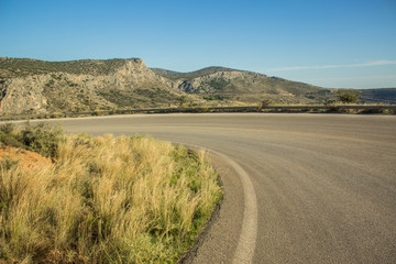 empty asphalt car road in dry summer warm place landscape with mountain rock on horizon background 