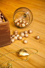 Golden nuts on the huge wineglass. Christmas and New Year